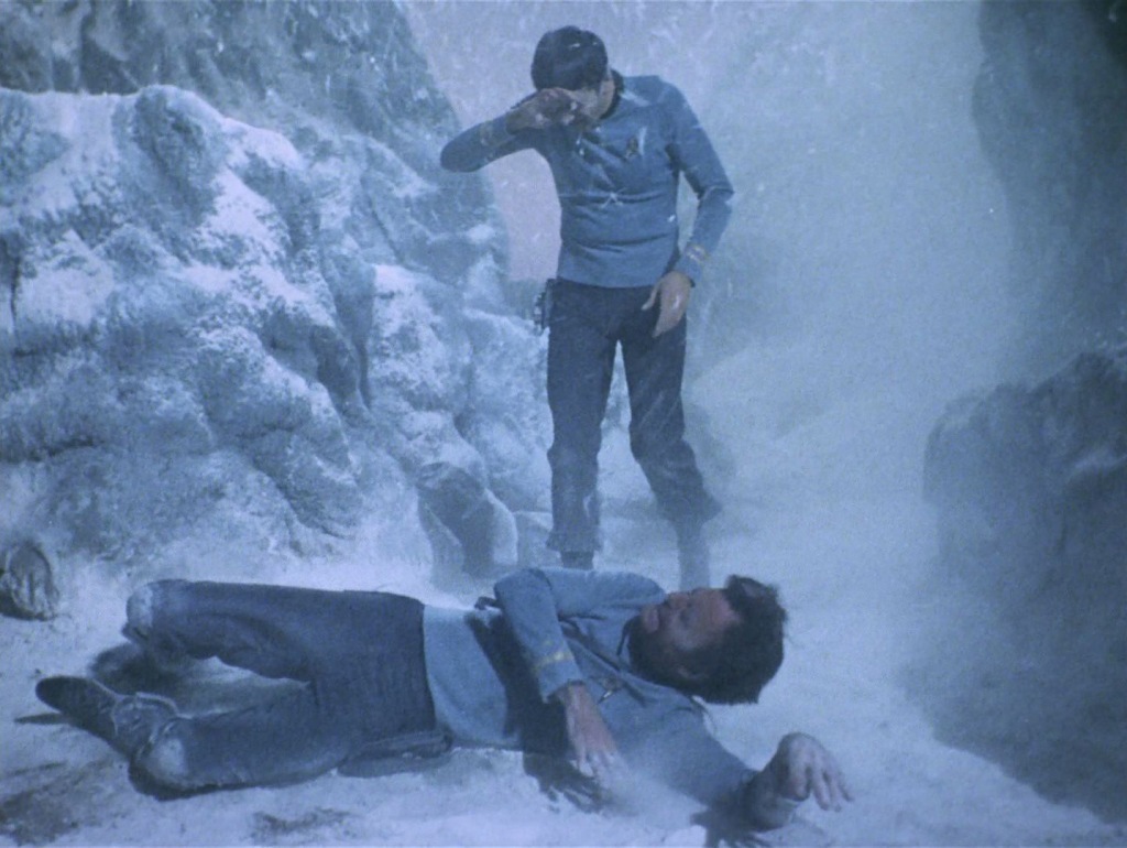 A scene from the Star Trek episode All Our Yesterdays. McCoy has just collapsed in a snow storm and Spock is about to help him. 